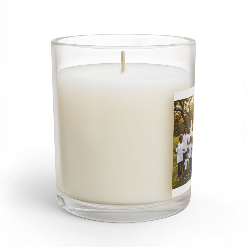a personalized glass jar candle with creamy off- white wax and a single wick featuring a printed photo of  group of children on the side set against a plain white background 