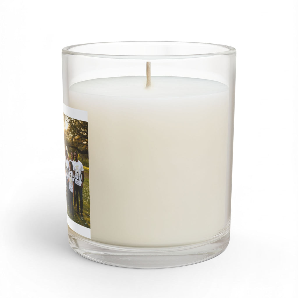 A clear glass jar candle with white wax and single wick, a printed photo wrapped  around the side on a clean white background